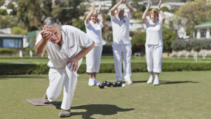 Older people playing lawn bowling